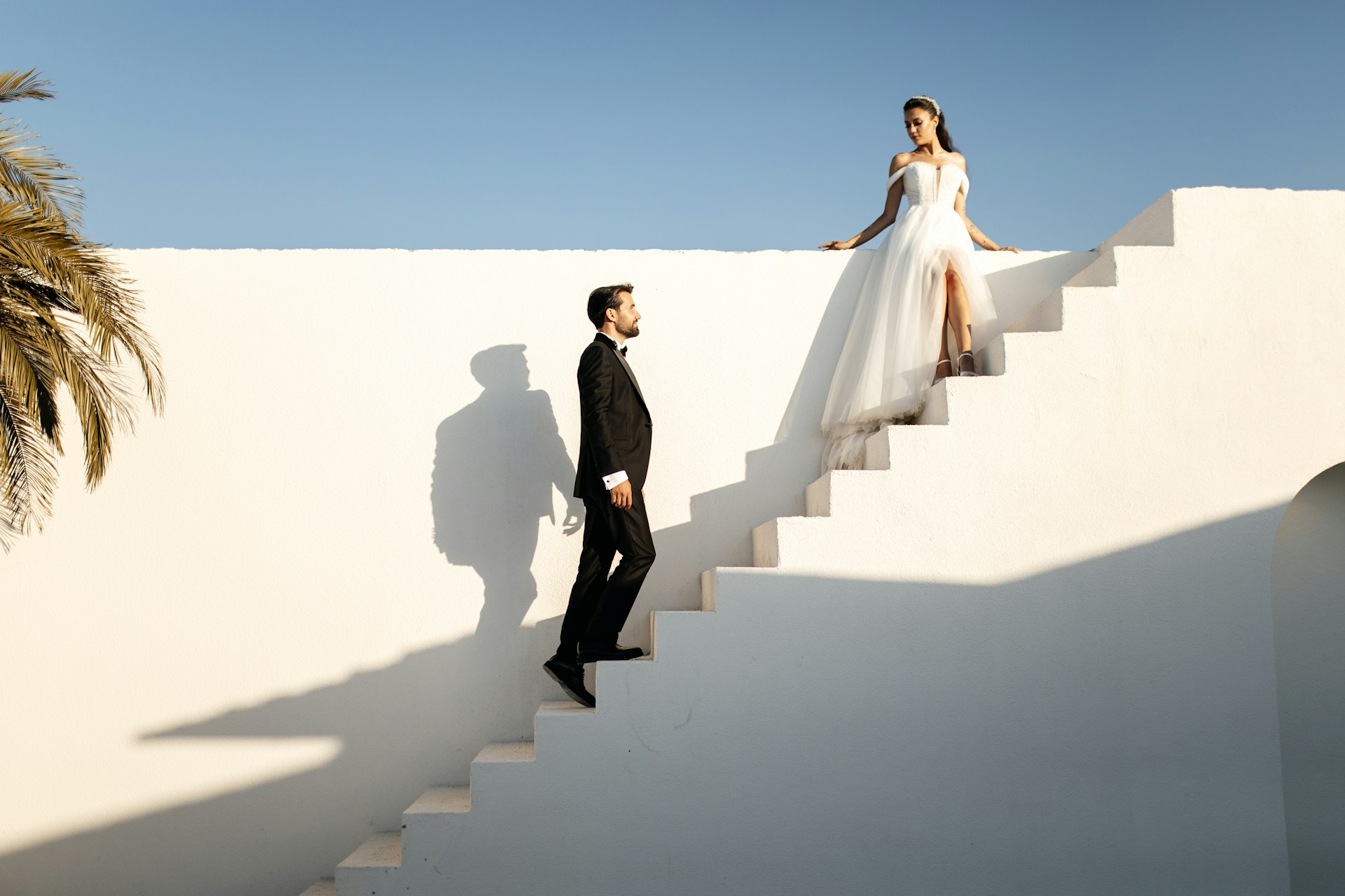 a groom ascending a staircase to meet his bride at the top a groom ascending a staircase to meet his bride at the top