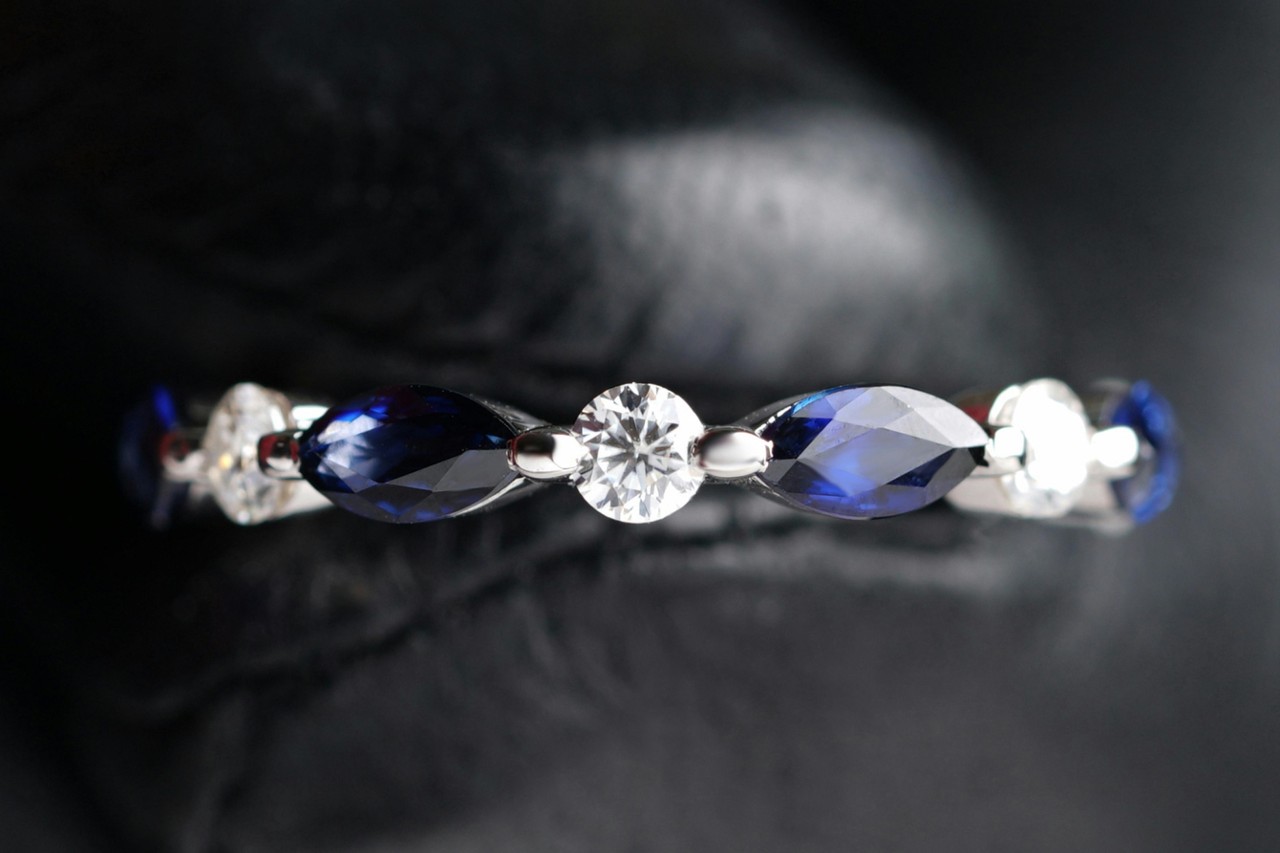 a diamond and sapphire wedding band in a white gold setting a diamond and sapphire wedding band in a white gold setting